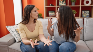 two people combatively talk about toxic friendships on a couch