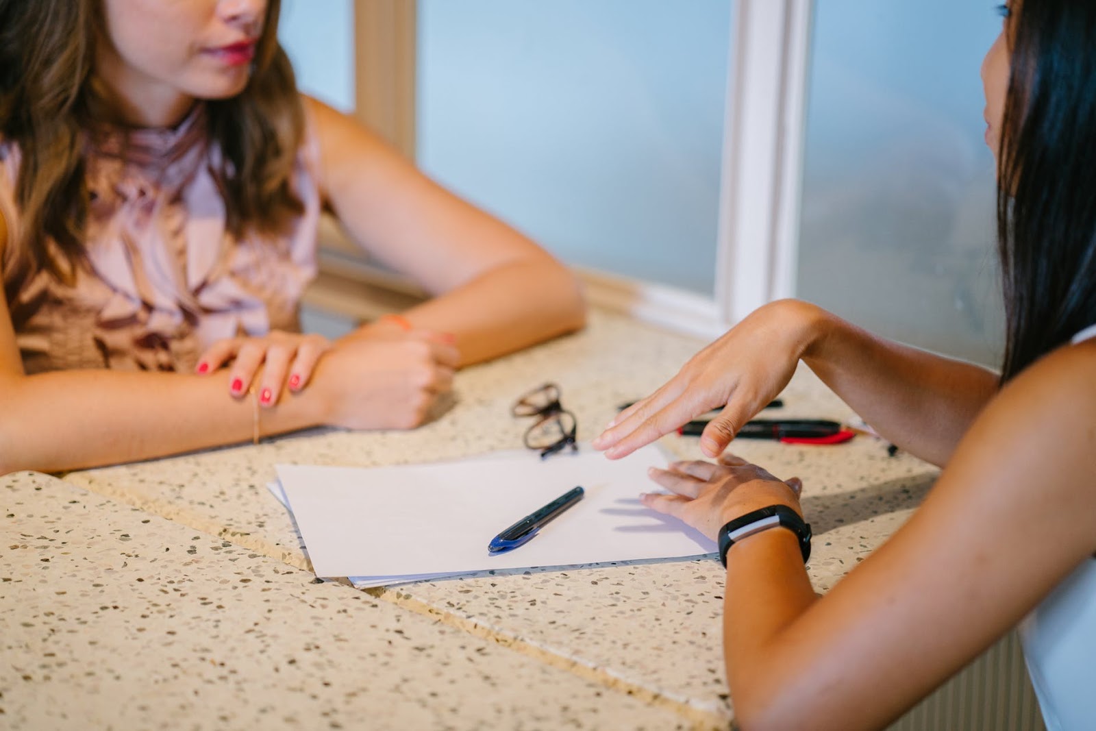 A woman is sitting down with her therapist ot discuss ways to create emotional support systems