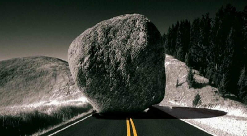 A boulder sits on a road, blocking the path towards your bad habit. 