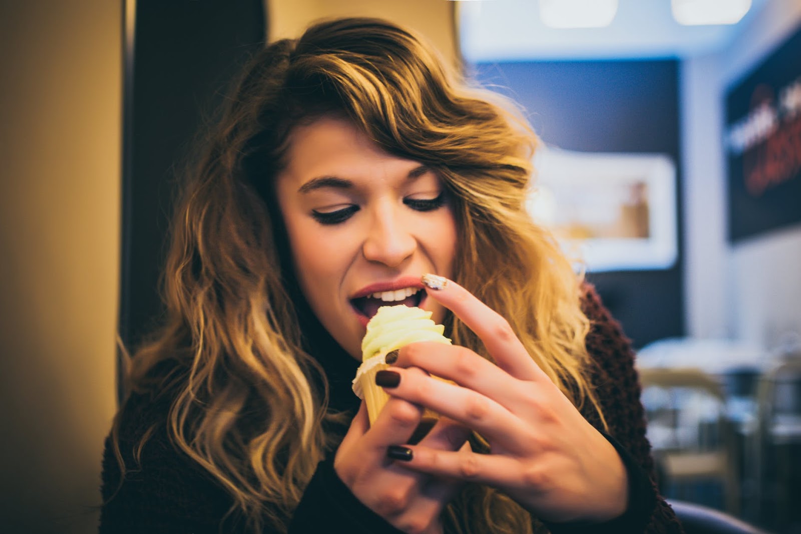 A woman treats herself with a cupcake after getting closer to kicking her bad habit. 