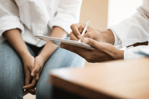 A patient listening to reasons to try TMS therapy